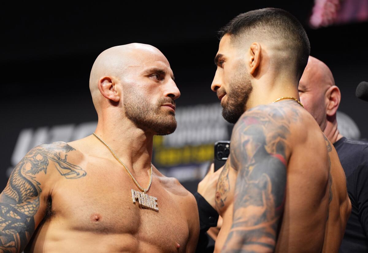 Alexander Volkanovski, left, and Ilia Topuria face off during the UFC 298 ceremonial weigh-in at Honda Center on Friday.