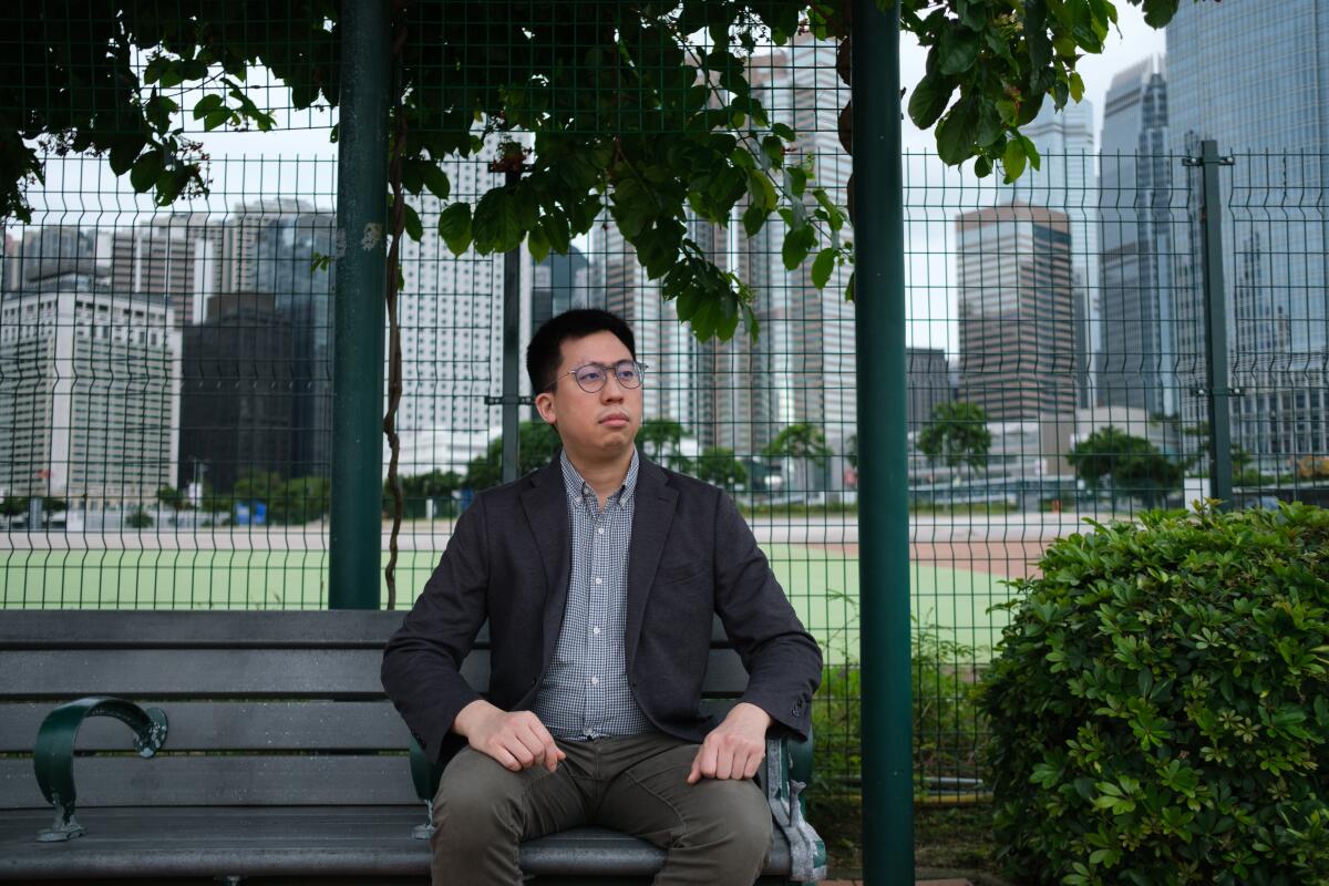A man sits on a bench in park 