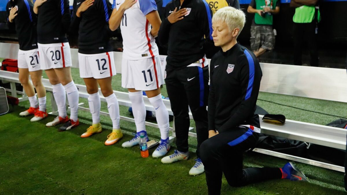 Megan Rapinoe kneels during the national anthem before a game against the Netherlands on Sept. 18, 2016, in Atlanta, Georgia.