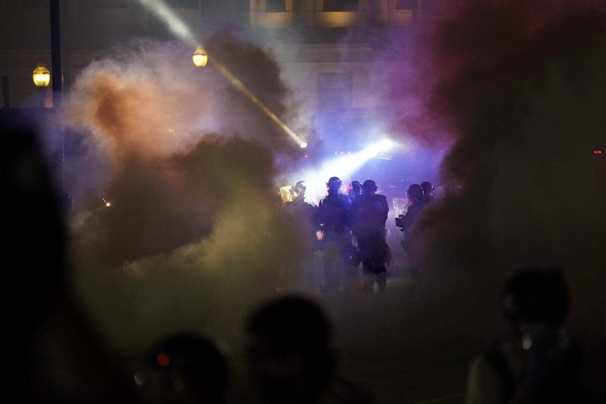 Police and protesters clash in Kenosha, Wis., on Aug. 25.