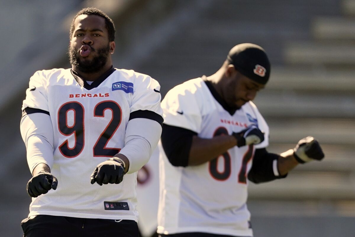 Cincinnati Bengals players B.J. Hill (92) and Quinton Spain (67) dance during warm ups during NFL football practice Wednesday, Feb. 9, 2022, in Los Angeles. The Cincinnati Bengals play the Los Angeles Rams in the Super Bowl Feb. 13. (AP Photo/Marcio Jose Sanchez)