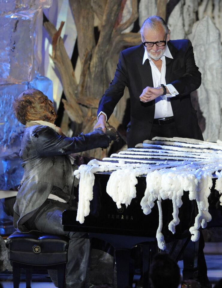 George Romero on stage with a zombie piano player at the Scream Awards in Los Angeles in 2009.
