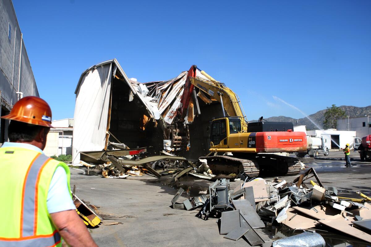 A bulldozer knocks down the first of 19 buildings at the old Western Studio Center to make way for a new IKEA store on the 800 block of S. San Fernando Rd. in Burbank on Thursday, March 26, 2015. The store, about one mile away from an existing IKEA, will have 456,00 sq. ft of space and will include 1,700 parking spaces on 22 acres of land. The store will open in the Spring 2017.