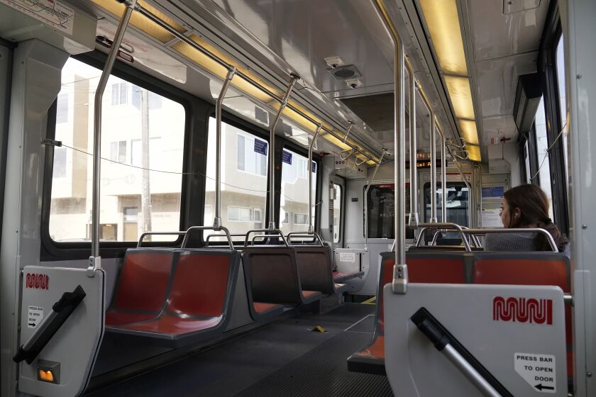 A passenger rides a mostly empty Muni streetcar in San Francisco, Tuesday, June 6, 2023. California's public transit agencies say they are running out of money, plagued by depleted ridership from the pandemic and soon-to-expire federal aid. But California's state government is having its own financial problems, leaving the fate of public transit agencies uncertain in this car-obsessed state. (AP Photo/Jeff Chiu)