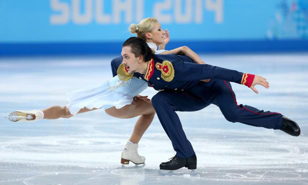 Russian figure skaters Tatiana Volosozhar and Maxim Trankov of Russia perform their pairs short program at the Sochi Winter Olympic Games on Tuesday.
