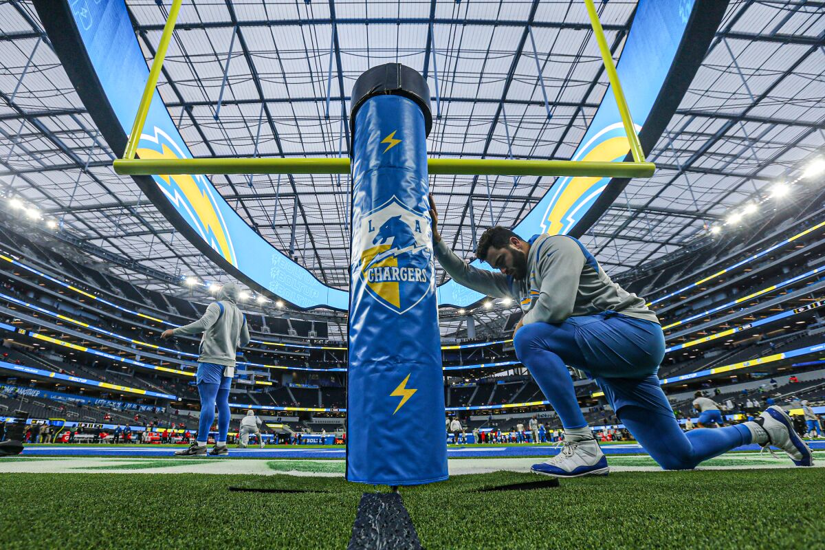 Chargers defensive lineman Joe Gaziano stretches in the end zone at SoFi Stadium before Thursday's game.