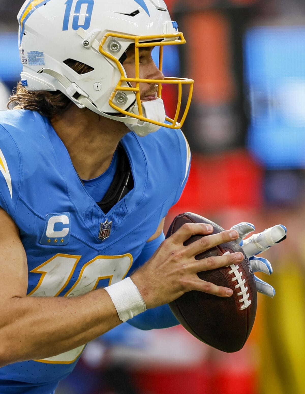 Herbert plays with a splint on his left middle finger against the Raiders.