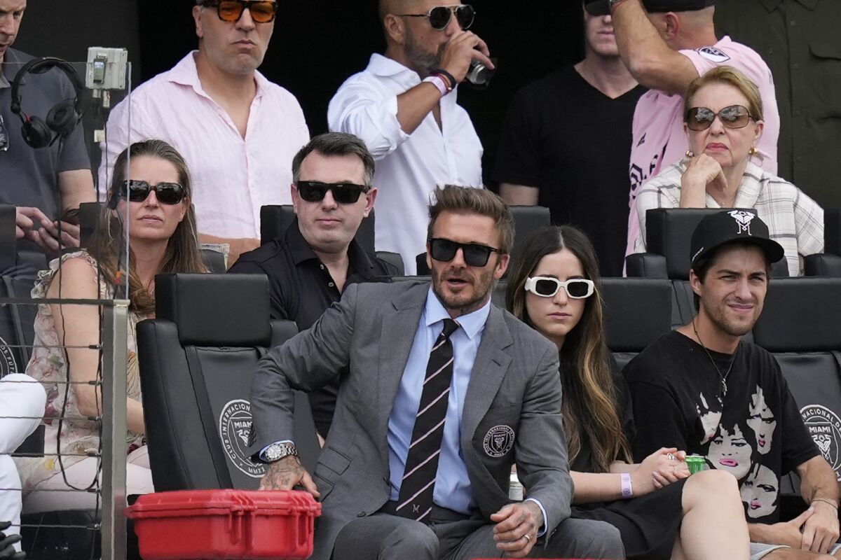 David Beckham, center, a co-owner and president of soccer operations for Inter Miami, watches an MLS soccer match against Los Angeles FC, Saturday, March 12, 2022, in Fort Lauderdale, Fla. (AP Photo/Rebecca Blackwell)