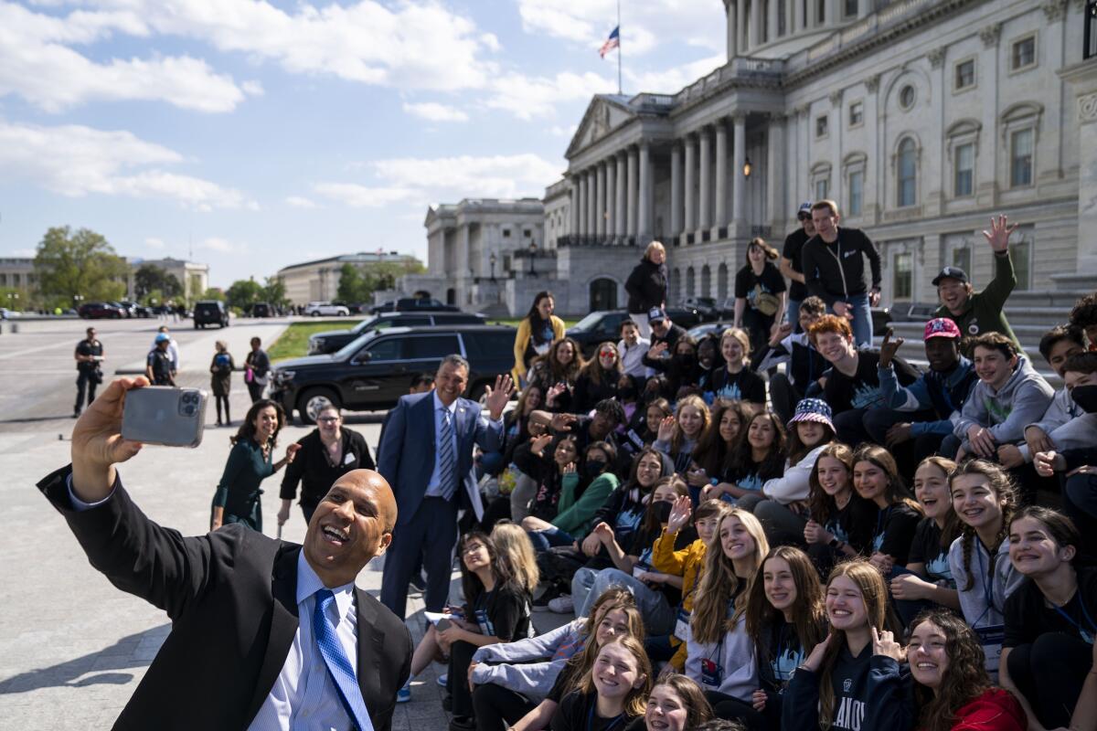 Sens. Alex Padilla (D-Calif.) and Cory Booker (D-N.J.) greet students on the steps of the Senate.