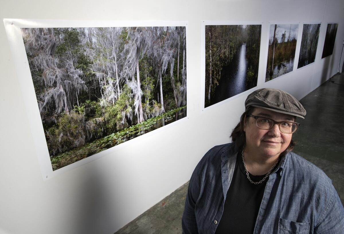 Catherine Opie before her images of swamps in her Lincoln Heights studio.
