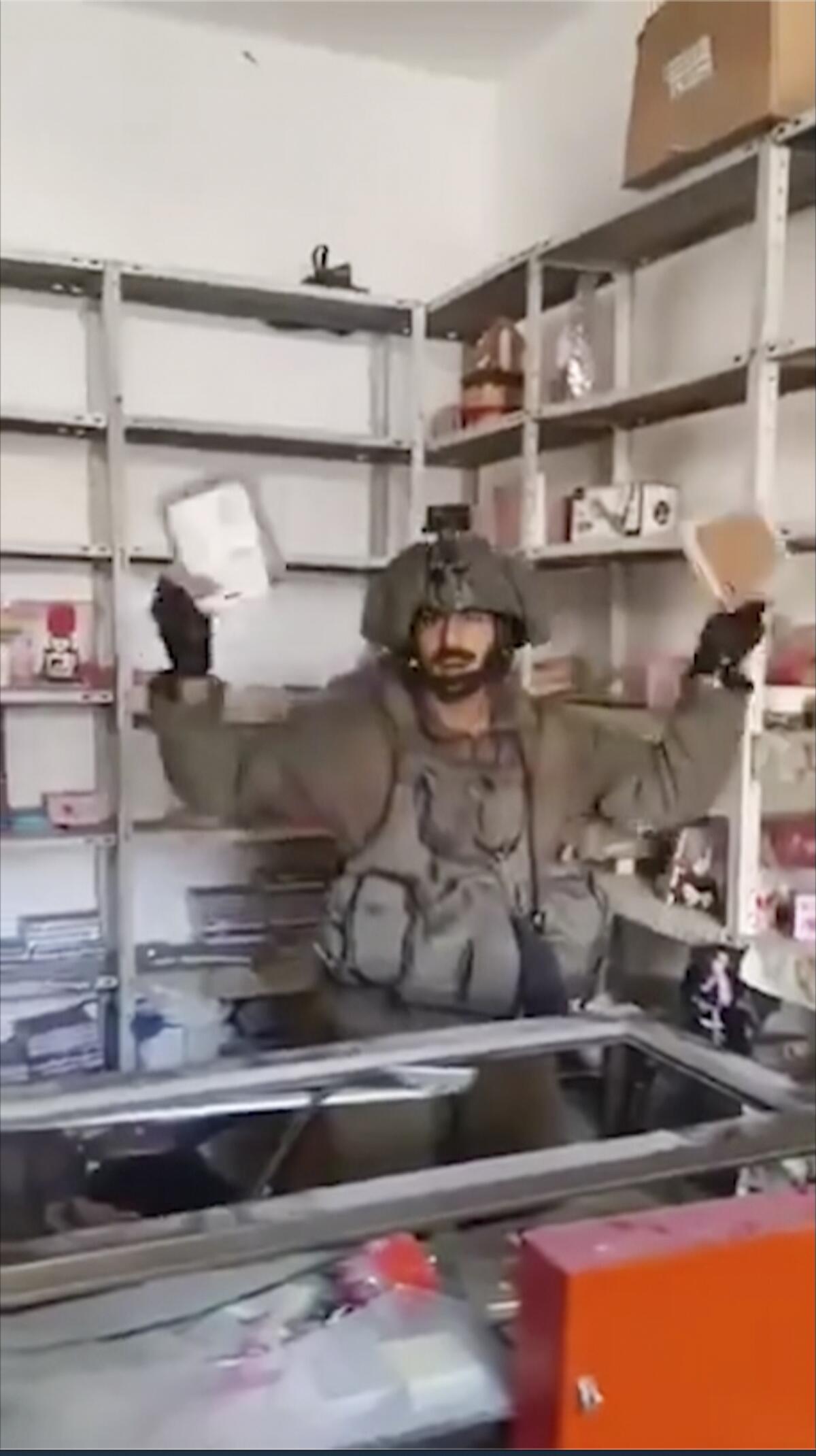 Israeli soldier holding up items in a Gaza home