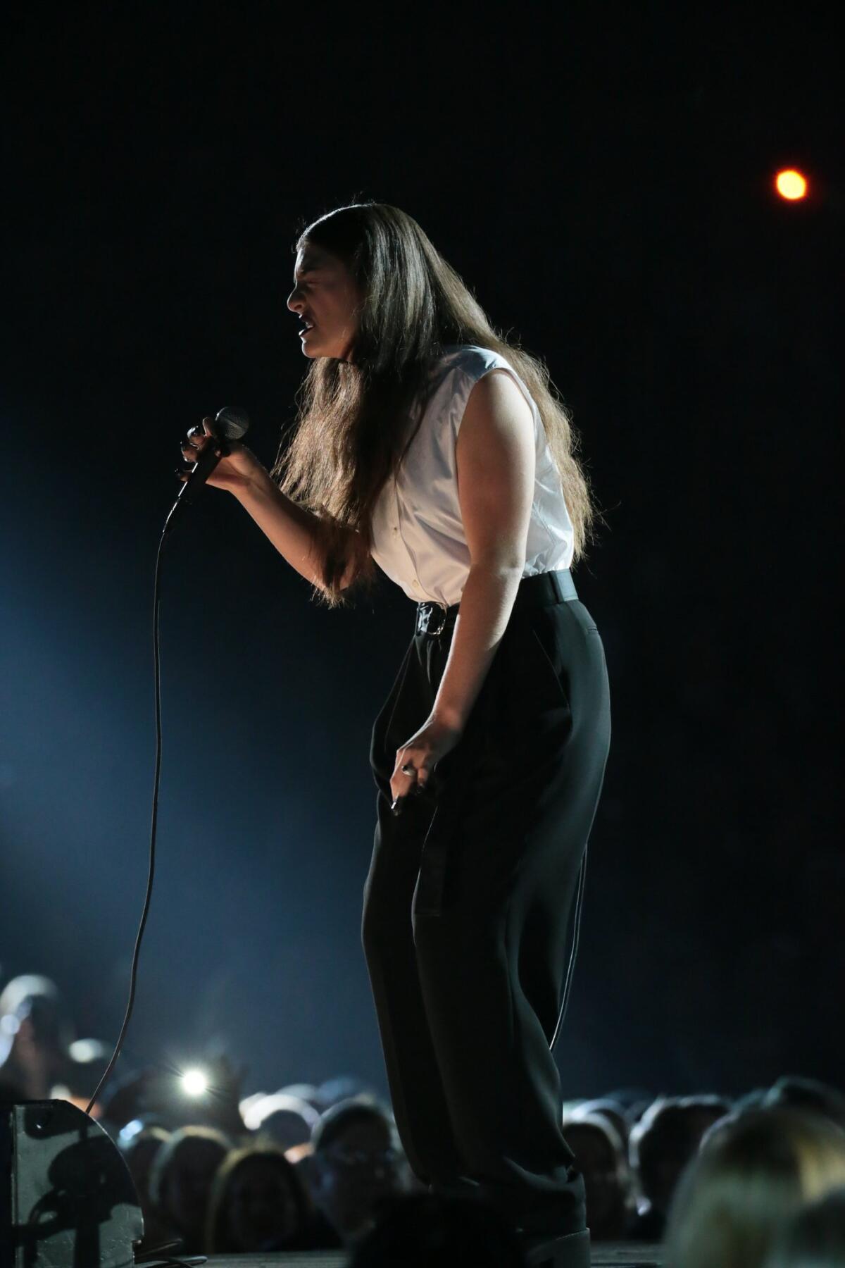 Lorde wears trousers and a white shirt to perform at the 56th Annual Grammy Awards at Staples Center in Los Angeles.