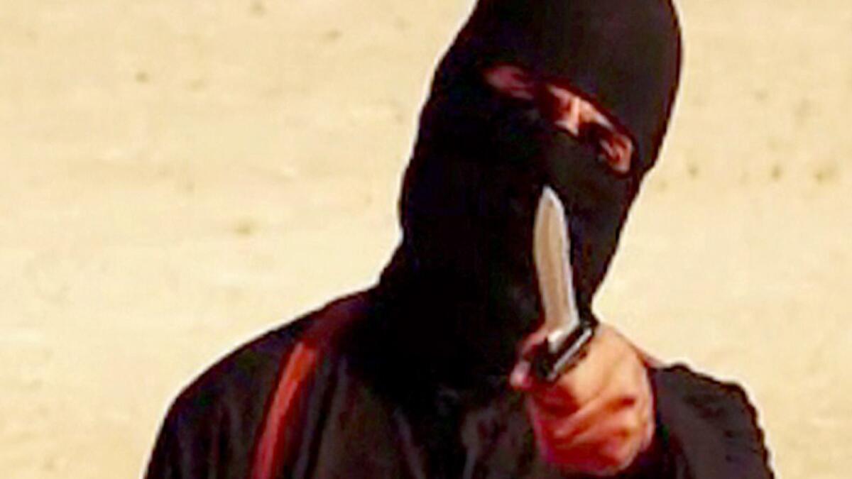A frame from a video released by Islamic State shows the masked militant "Jihadi John" before beheading U.S. hostage Steven Sotloff.