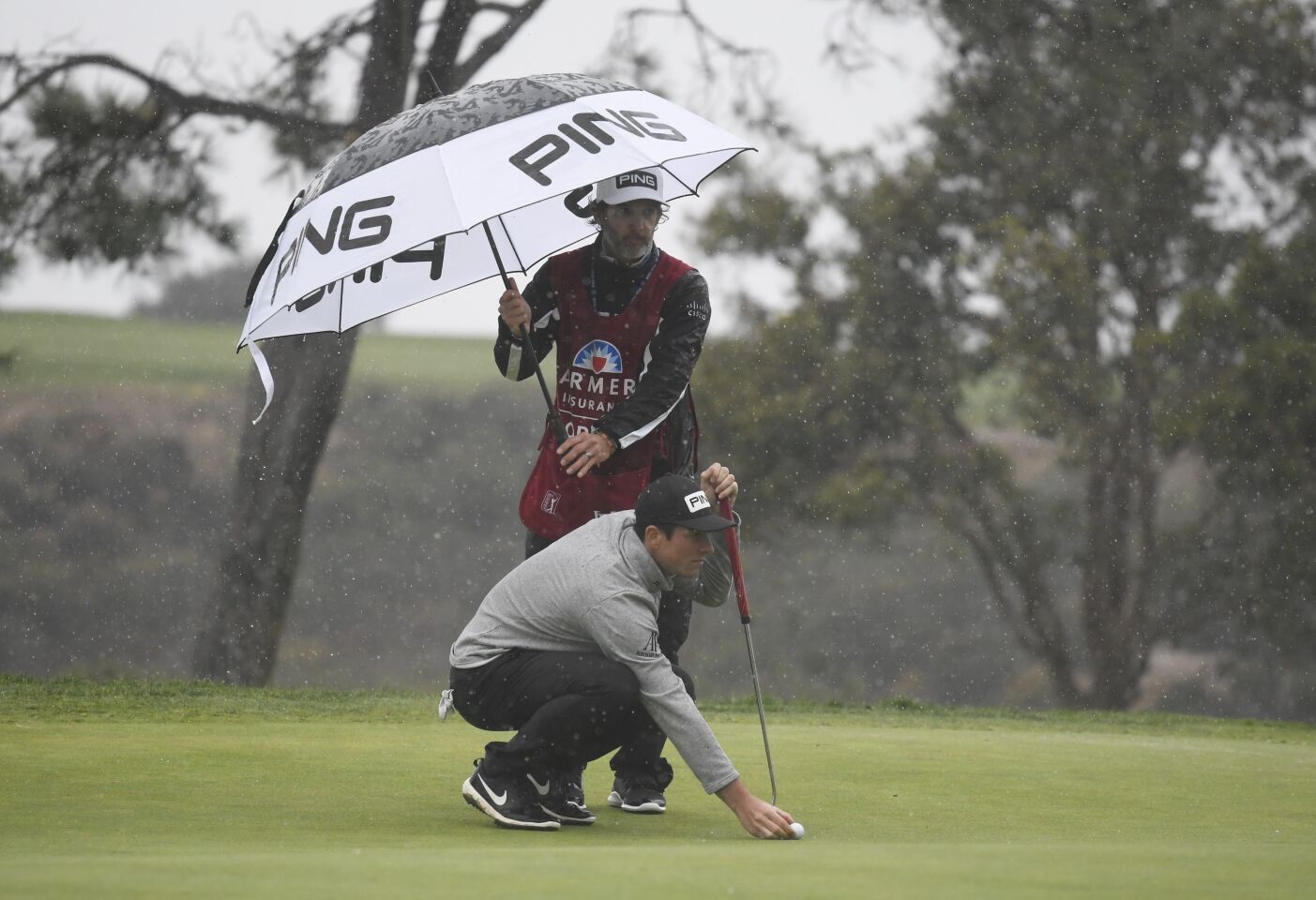 Viktor Hovland, of Norway, lines up a putt on the eighth green of the South Course during the second round of the Farmers Insurance Open golf tournament at Torrey Pines, Friday, Jan. 29, 2021, in San Diego. (Photo by Denis Poroy)