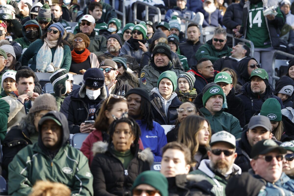 Fans watch during the first half of an NFL football game between the New York Jets and the Jacksonville Jaguars at MetLife Stadium Sunday, Dec. 26, 2021, in East Rutherford, N.J. (AP Photo/Corey Sipkin)