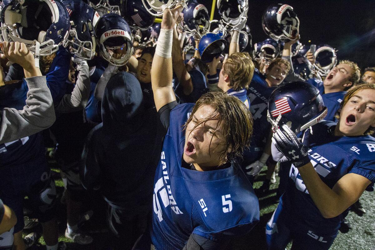 Newport Harbor celebrates after pulling off a 24-20 come-from-behind win against Monrovia in the quarterfinals of the CIF Southern Section Division 9 playoffs on Friday at Davidson Field.