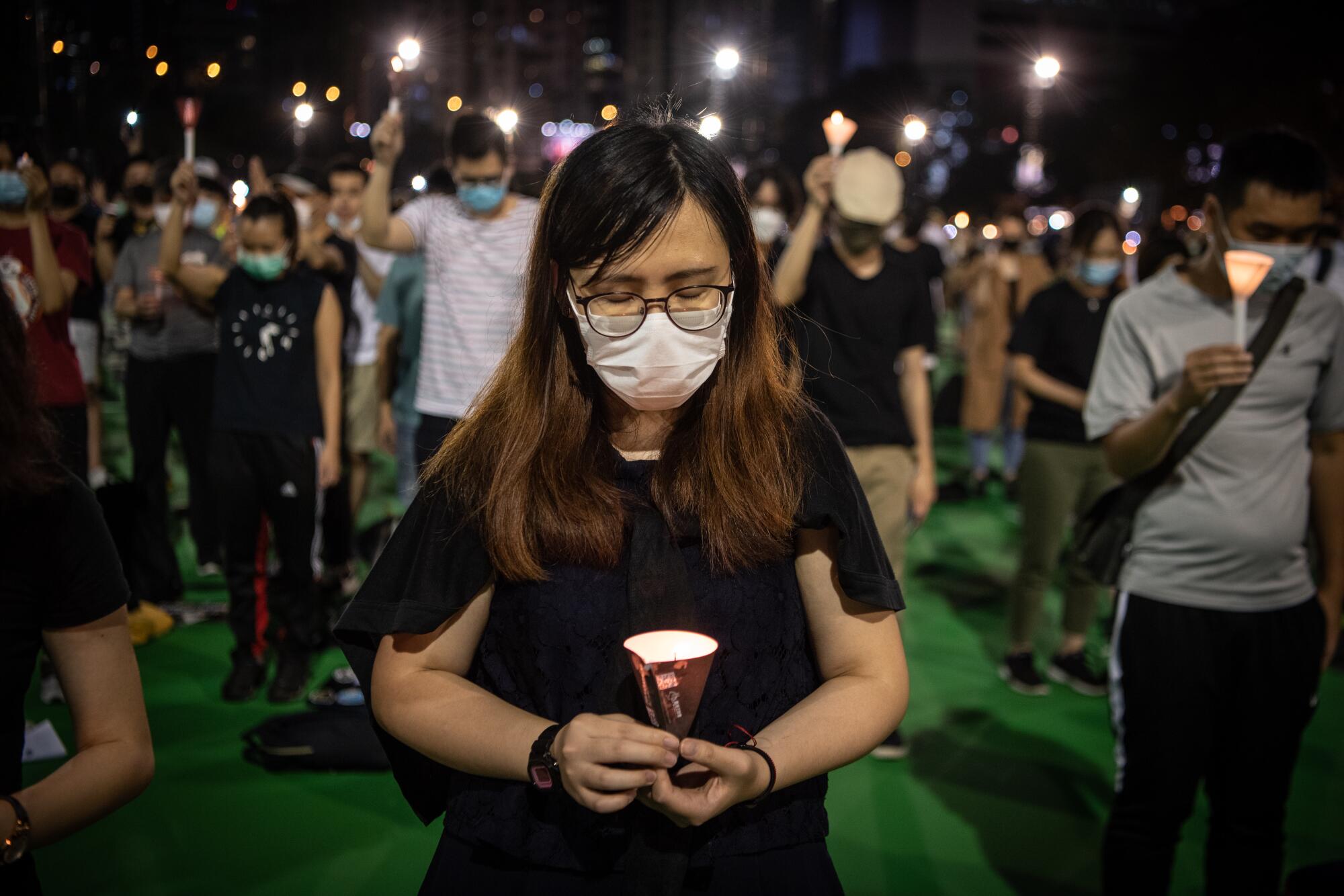 A woman attends an illegal commemoration in Hong Kong of the 1989 Tiananmen Square protests. 
