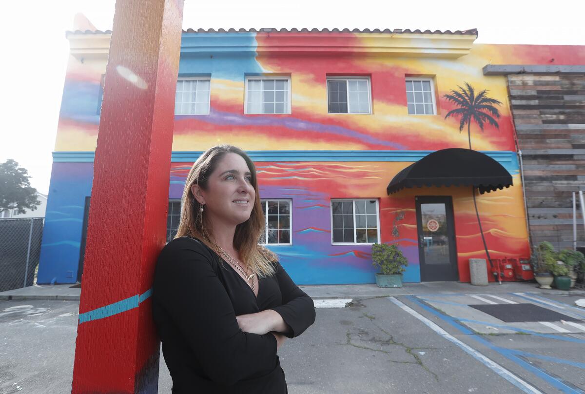 Melissa Murphy, better known as "Melissa Murals," pictured in front of the Sunset Lounge.