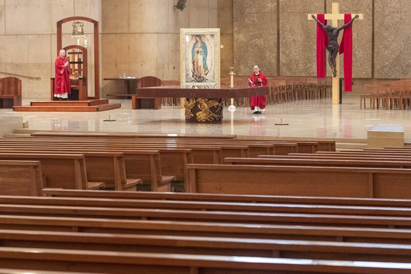Clergy celebrate Good Friday in a nearly empty Cathedral of Our Lady of the Angels in April.