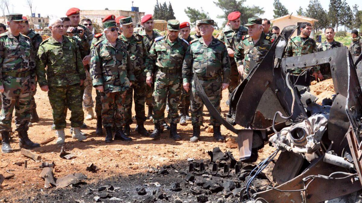 A photograph from the Syrian Arab news agency SANA shows Syrian Chief of the General Staff of the Army and Armed Forces Gen. Ali Abdullah Ayoub, third from left, inspecting the damage at the Shayrat airbase.