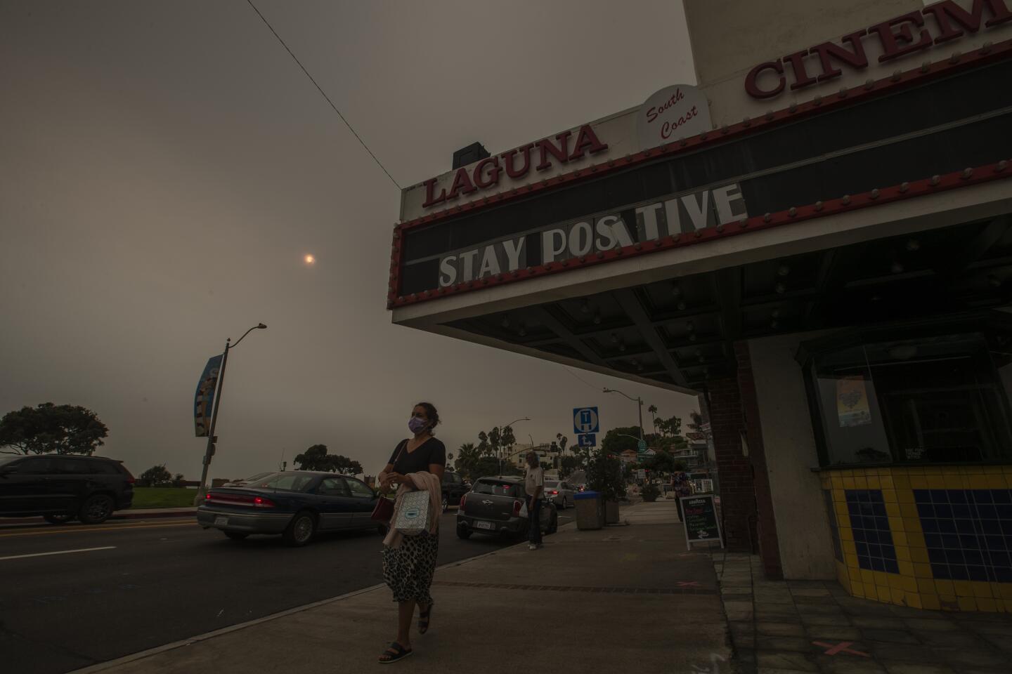 An upbeat message on the South Coast Cinemas marquee in Laguna Beach is dimmed by smoky air.