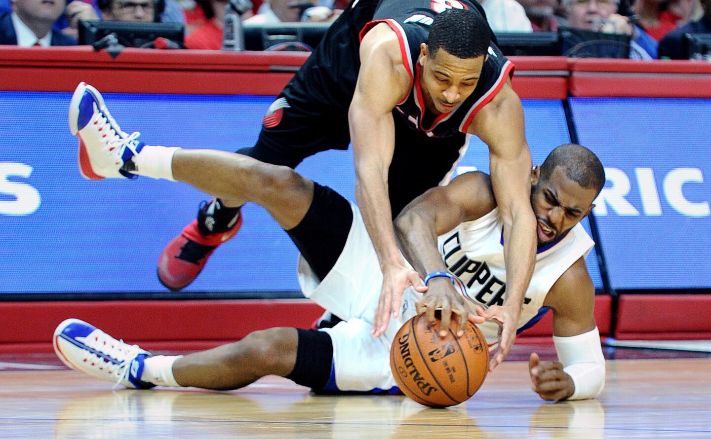 Clippers guard Chris Paul is fouled by Trail Blazers guard C.J. McCollum during a battle for the ball in the fourth quarter of Game 1.