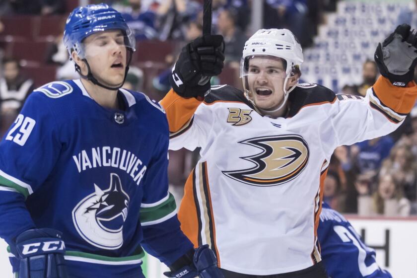 Anaheim Ducks' Sam Steel, right, celebrates teammate Kiefer Sherwood's goal as Vancouver Canucks Ashton Sautner skates past during the third period of an NHL hockey game in Vancouver, British Columbia, Tuesday, March 26, 2019. (Darryl Dyck/The Canadian Press via AP)