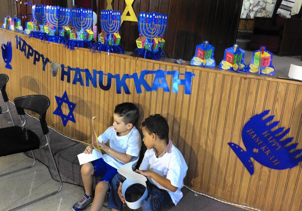 Children with paper likenesses of candle flames are among Cubans celebrating Hanukkah at Temple Beth Shalom in Havana.