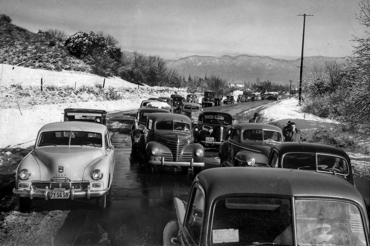 Jan. 12, 1949: Cars line up on Sepulveda Boulevard in Sherman Oaks while waiting for ice to melt before driving over a hill to the Beverly Hills area. Cars with chains were allowed through. At noon the road was opened.