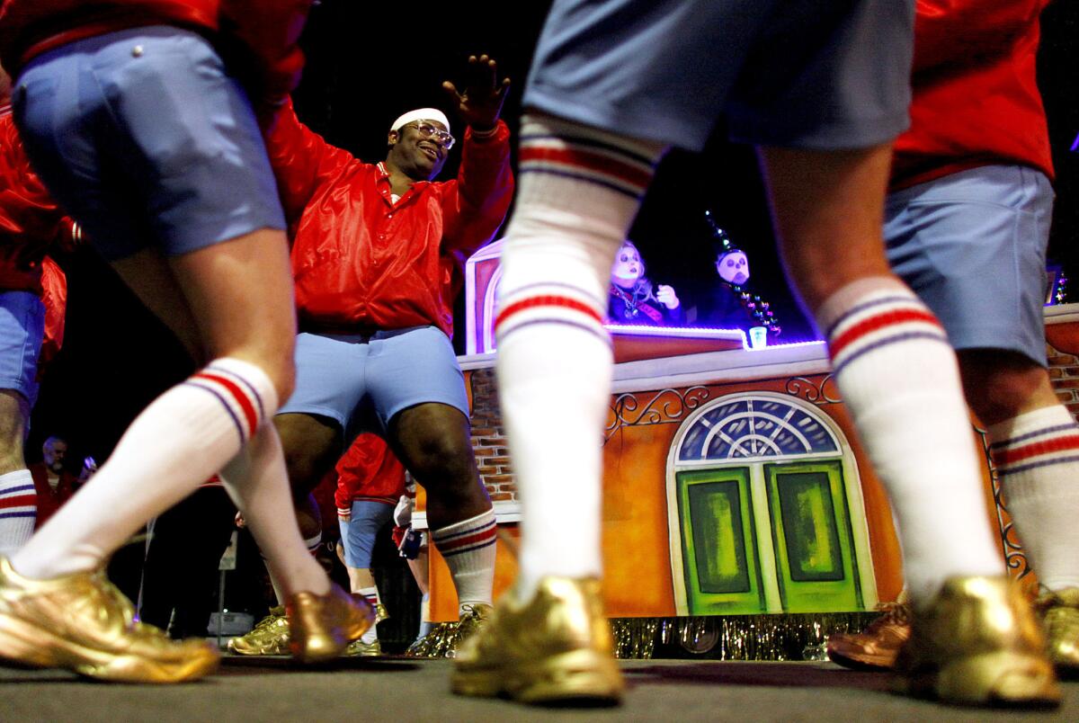 Dante Hale of the 610 Stompers all-male marching club does a warm-up dance with fellow Stompers before marching with the Krewe of Nyx in New Orleans.