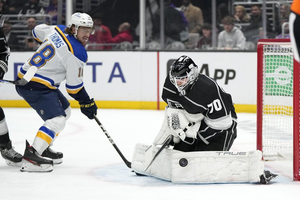 Kings goalie Joonas Korpisalo stops a shot as Blues center Robert Thomas looks on during the first period March 4, 2023.