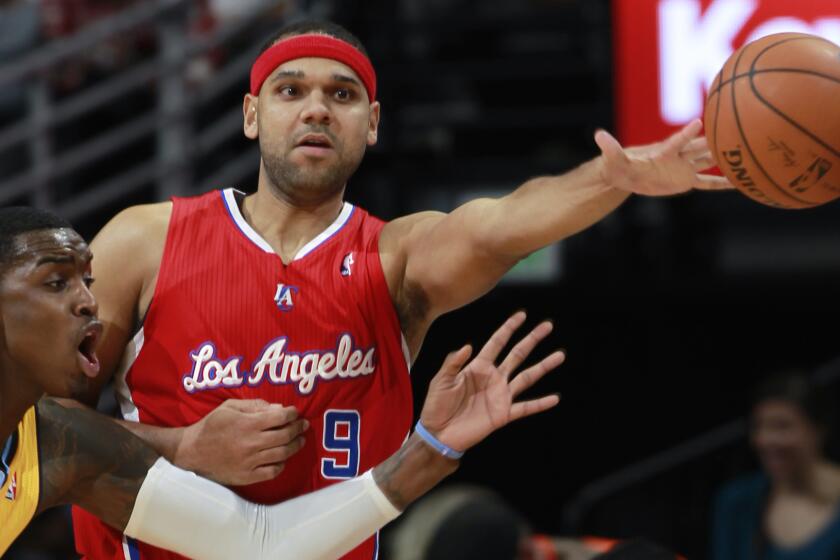 Clippers forward Jared Dudley, right, passes ball as Denver Nuggets forward Quincy Miller during a game in February. The Clippers traded Dudley to the Milwaukee Bucks on Tuesday.