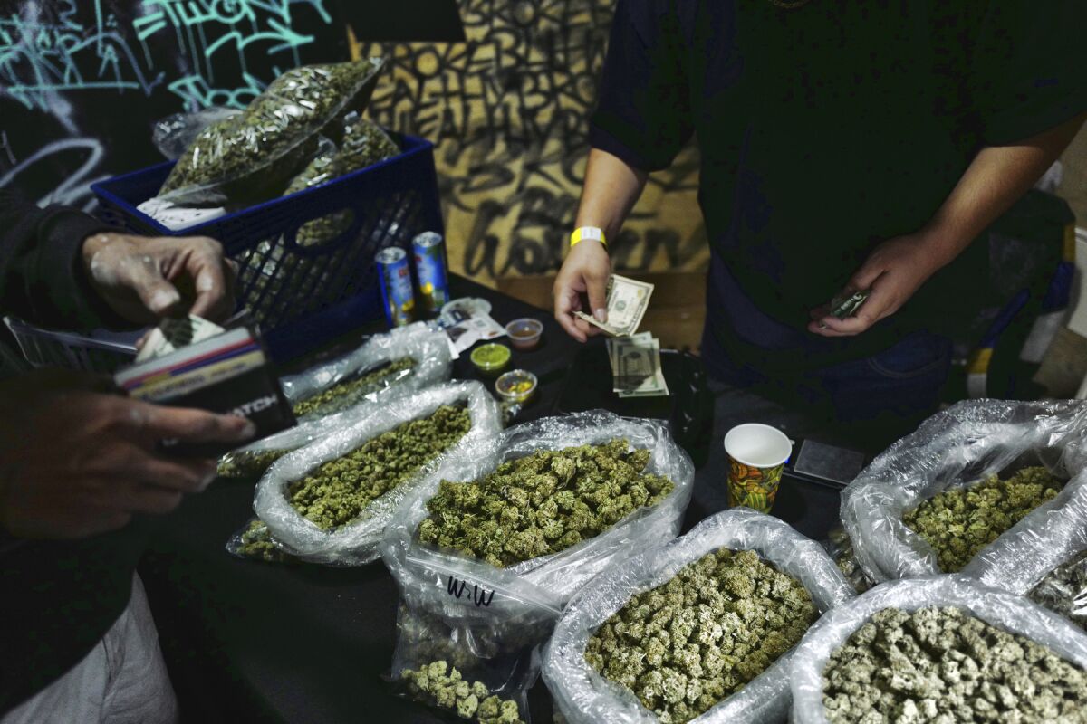 Bags of marijuana being sold for cash at a marketplace in Los Angeles.