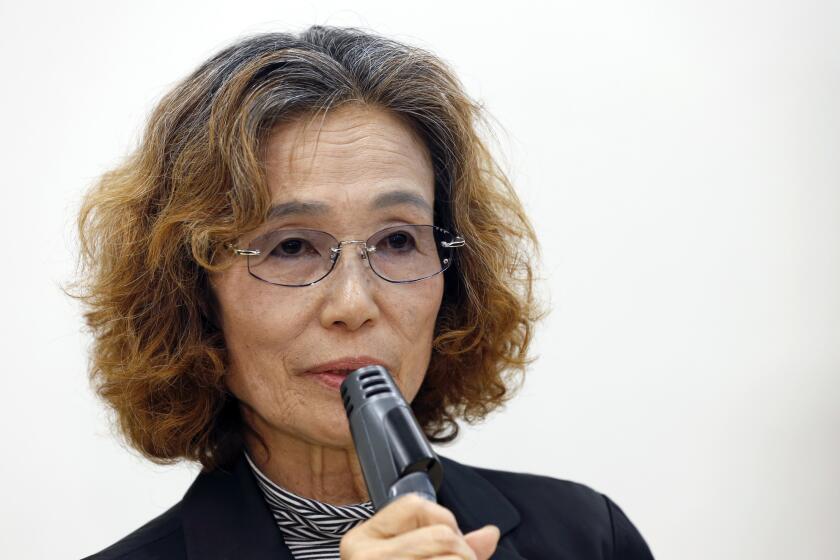 Junko Ishido, mother of Kenji Goto, a Japanese hostage held by Islamic State militants, appears at a Tokyo news conference to appeal to Japan's prime minister to intervene on her son's behalf.