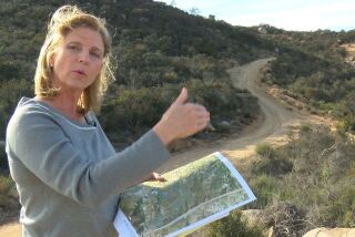 Escondido CA.- March 5, 2018,- Rita Brandin, Sr. VP ad Development Director for Newline Sierra, with a map near the high point of the property. The 1,800 acres of the proposed Newland Sierra development project is in the Twin Oaks area north of Escondido. 2,135 residential units are planned and a small commercial development. PHOTO/JOHN GIBBINS, Staff photographer, San Diego Union-Tribune) copyright 2018