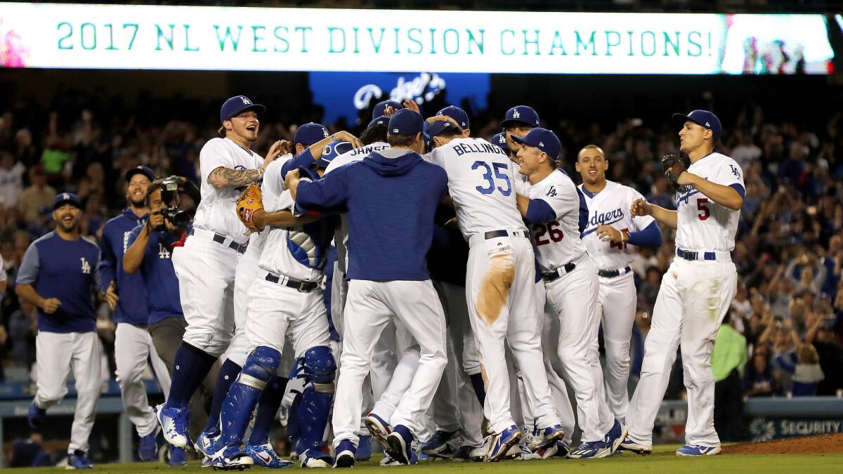 The Dodgers celebrate after beating the Giants at Dodger Stadium on Friday night to clinch the NL West title.