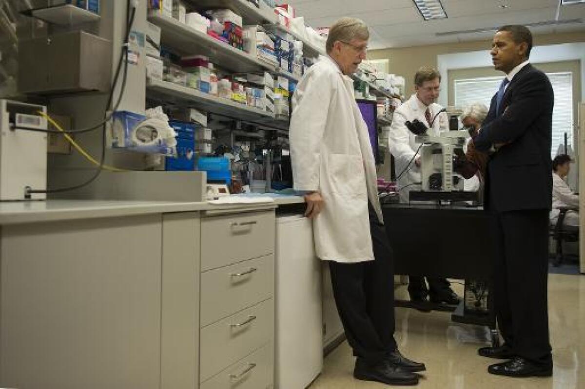 President Obama speaks with NIH Director Francis Collins in 2009.