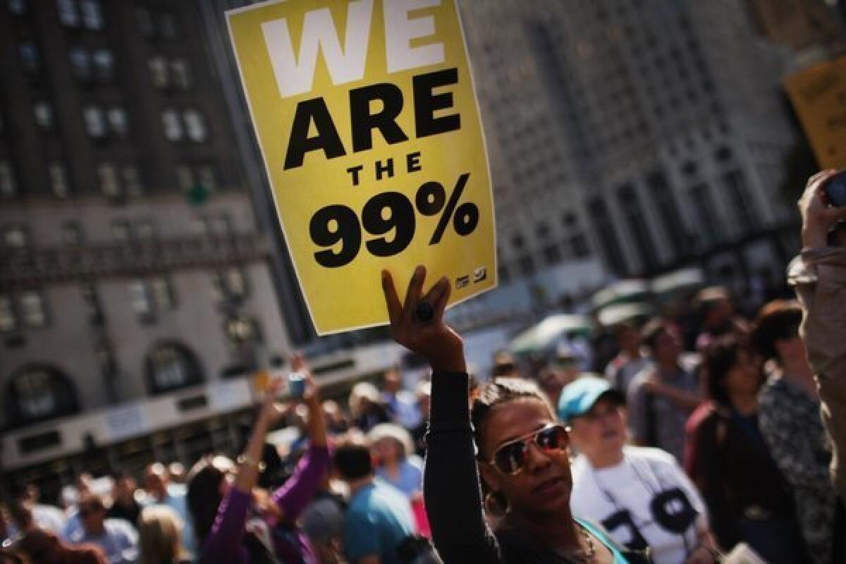 An Occupy Wall Street supporter holds up a sign during a 2011 protest on Fifth Avenue in New York City.