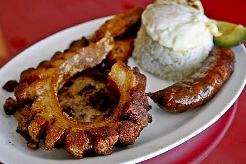 Bandeja Paisa: This dish of fried pork, Colombian sausage, egg, fried plantains and avocado is on the menu at El Bolivar.