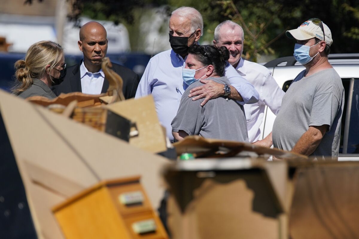 President Joe Biden hugs a person as he tours Manville, N.J.