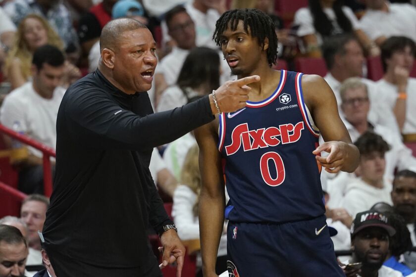 Philadelphia 76ers head coach Doc Rivers talks to guard Tyrese Maxey (0) on the sidelines during the first half of Game 1 of an NBA basketball second-round playoff series against the Miami Heat, Monday, May 2, 2022, in Miami. (AP Photo/Marta Lavandier)