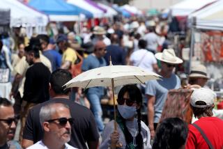 LONG BEACH, CALIF. - APR. 17, 2022. People look for vintage items and bargains at the Long Beach Flea Market on Sunday, Apr. 17, 2022. (Luis Sinco / Los Angeles Times)