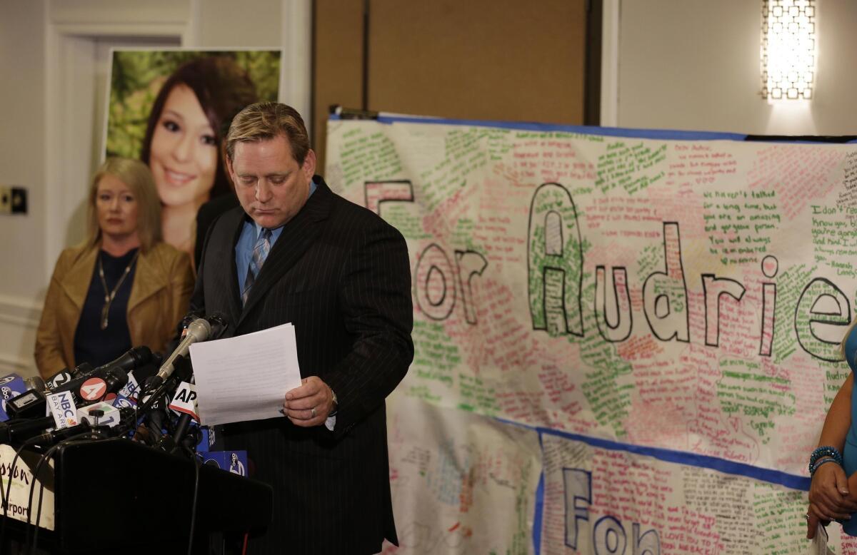 Larry Pott, father of Audrie Pott, who committed suicide after she was sexually assaulted, reads a statement at a news conference in San Jose. Audrie's mother, Sheila Pott, is at left.