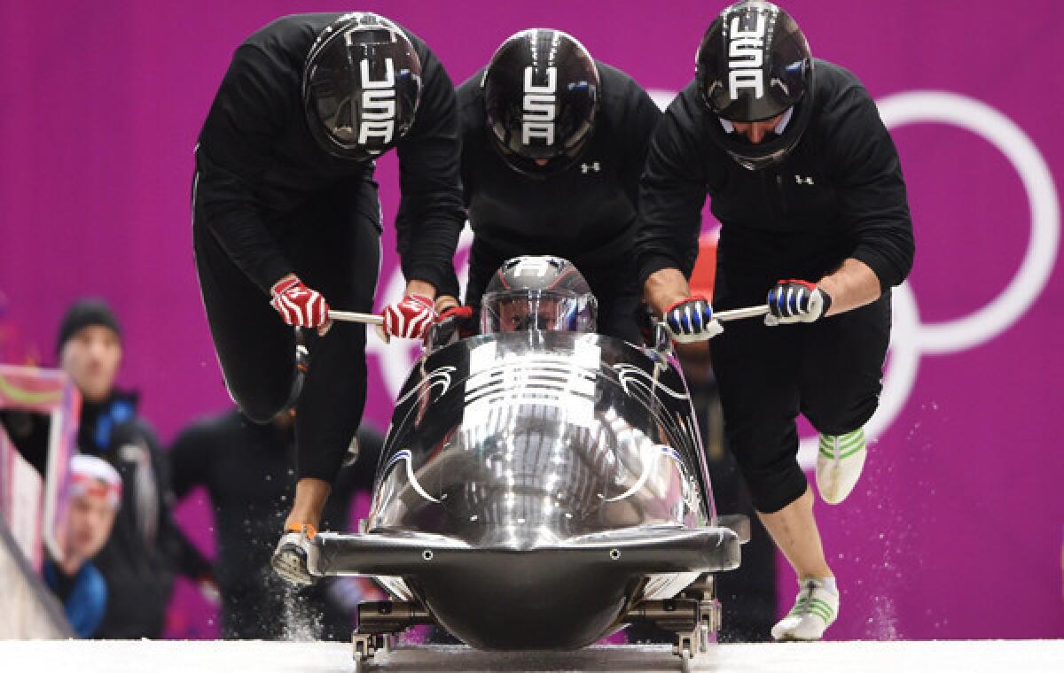 USA's four-man bobsled team takes part in a training run at the Sochi Winter Olympic Games on Wednesday. Pilot Steven Holcomb, sitting in bobsled, is dealing with a calf injury that could threaten the team's chances at winning gold.