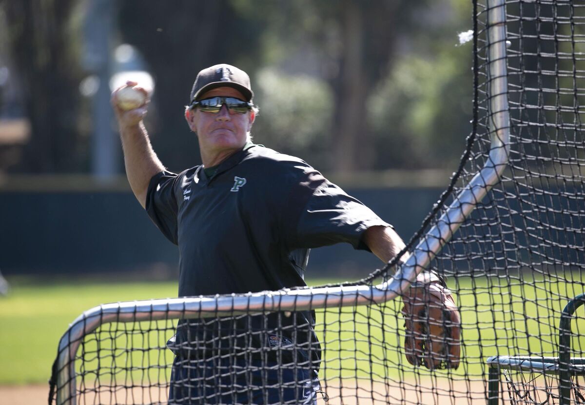 Poway High School baseball coach Bob Parry throws batting practice during a 2020 workout. 