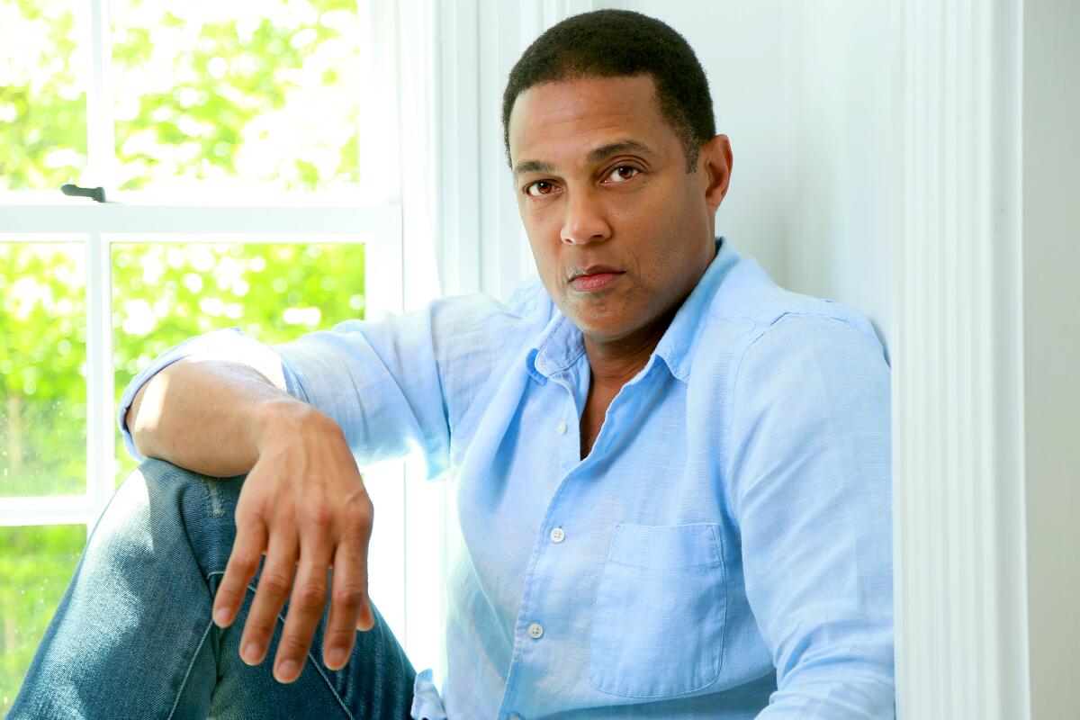 Don Lemon sitting on a windowsill with an arm resting on one knee