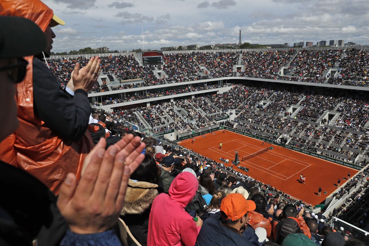 FILE - Spectators applaud Spain's Rafael Nadal and Switzerland's Roger Federer during their semifinal match of the French Open tennis tournament on center court at the Roland Garros stadium in Paris, on June 7, 2019. The French Tennis Federation said Wednesday, May 4, 2022, that the French Open prize money will increase by nearly seven percent to $46 million (43.6 million euros) compared to the pre-coronavirus edition of 2019. (AP Photo/Pavel Golovkin, File)