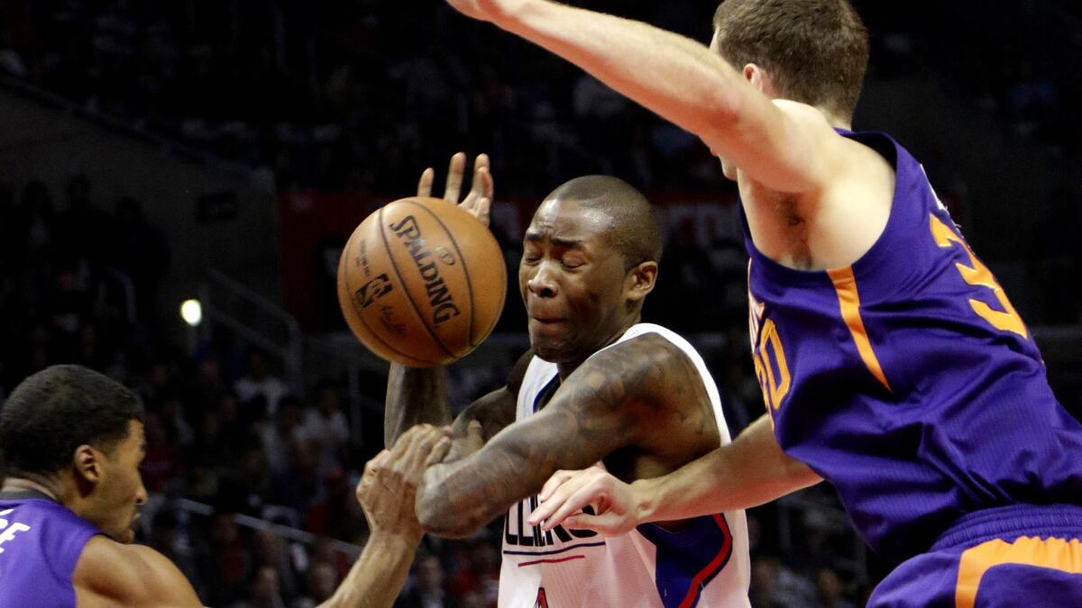 Clippers guard Jamal Crawford is fouled as he drives against the Suns on Monday night.