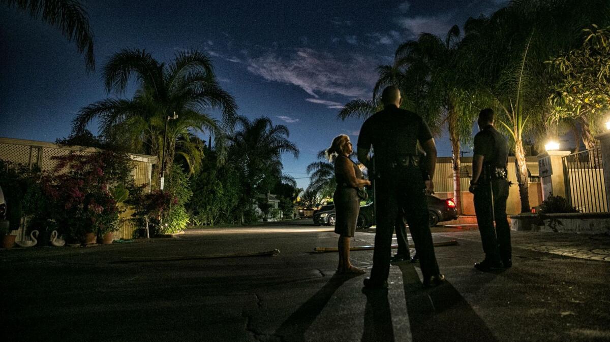 LAPD officers investigate a reported disturbance in a Sylmar mobile home park.