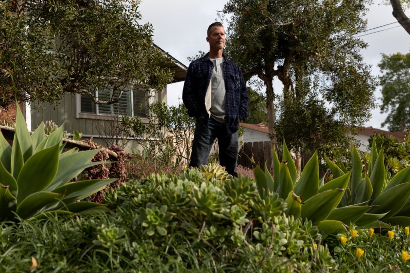 Nick Voinov poses at the front yard of his La Mesa home on Tuesday, Feb. 21, 2023. Voinov won the WaterSmart Landscape Contest in 2022.